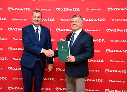 wicemarszałek Wiesław Raboszuk i przedstawiciel gminy Lesznowola, panowie podają sobie dłoń po podpisaniu umowy