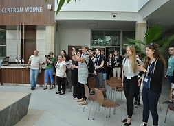 Grupa młodzieży w budynku pod napisem Centrum Wodne.
