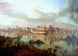 obraz Canaletta z 1770 r. pt.„Widok Warszawy od strony Pragi” - widok na stare miasto z czerwonymi wiezyczkami. Po wiśle pływają statki