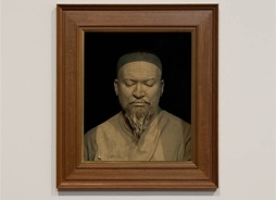 Portret mężczyzny z brodą oprawiony w ramy.