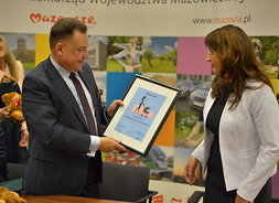Marszałek Adam Struzik przekazuje dyplom  Renacie Kaznowskiej zastępcy prezydenta m.st. Warszawy