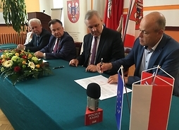 Beneficjenci podpisują umowę w starostwie powiatowym w Mławie