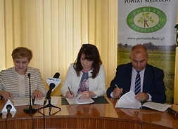 Umowę podpisują od lewej członek zarządu Elżbieta Lanc, wicemarszałek Janina Ewa Orzełowska oraz starosta siedlecki Dariusz Stopa
