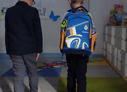 Uczniowie prezentują odblaski na plecakach