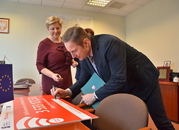 Burmistrz Sochaczewa Piotr Osiecki podpisuje symboliczny czek