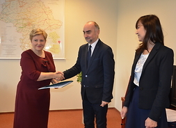 Członek zarządu województwa mazowieckiego Elżbieta Lanc gratuluje burmistrzowi Piastowa Grzegorzowi Szuplewskiemu
